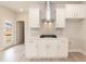 Bright white kitchen with stainless hood, white cabinets, and stone countertops at 136 Newport Lndg, Garner, NC 27529