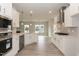 Open kitchen featuring stainless appliances, quartz countertops, and light wood flooring at 136 Newport Lndg, Garner, NC 27529