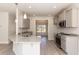 An open kitchen boasts granite countertops, stainless appliances, and gray cabinets at 136 Newport Lndg, Garner, NC 27529