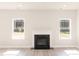 Living room features a fireplace, wood-look floors, and lots of natural light at 136 Newport Lndg, Garner, NC 27529