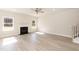 Spacious living room with a fireplace, hardwood floors, and plenty of natural light at 136 Newport Lndg, Garner, NC 27529