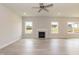 Spacious living room with a fireplace, wood floors, and large windows, offering a warm and inviting atmosphere at 136 Newport Lndg, Garner, NC 27529
