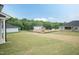 Backyard view of construction in progress, new homes with landscaping and wooded area in the distance at 136 Newport Lndg, Garner, NC 27529