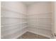 Walk-in pantry with wire shelving and wood-look floors at 136 Newport Lndg, Garner, NC 27529