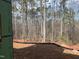 View of wooded property boundary with a black and orange construction barrier at 162 Gaines Trail, Pittsboro, NC 27312