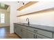 Stylish bar area with sleek countertops, floating shelves, and wood-look flooring at 162 Gaines Trail, Pittsboro, NC 27312