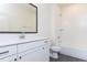 Clean, bright bathroom features white cabinetry, large mirror, and tub/shower combo at 162 Gaines Trail, Pittsboro, NC 27312