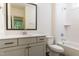 Well-lit bathroom with a framed mirror, modern vanity, and a combined tub and shower at 162 Gaines Trail, Pittsboro, NC 27312