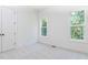 Neutral bedroom with plush carpeting and two windows letting in natural light at 162 Gaines Trail, Pittsboro, NC 27312