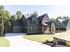 Home with a large driveway, lawn, brick accents, and multiple car garage at 162 Gaines Trail, Pittsboro, NC 27312