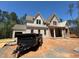 New two story home featuring brick and siding exterior, a covered porch, and an attached garage under construction at 162 Gaines Trail, Pittsboro, NC 27312