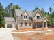 Attractive two-story home with gray roof, brick, siding, and manicured front yard; awaiting final installation at 162 Gaines Trail, Pittsboro, NC 27312
