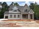 Charming two-story home with brick and siding, featuring a covered front porch and attached garage at 162 Gaines Trail, Pittsboro, NC 27312