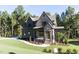 Beautiful craftsman style home with brick and siding, shutters, with a manicured front yard at 162 Gaines Trail, Pittsboro, NC 27312