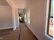 Long hallway with multiple windows, offering ample natural light and views of the outdoors at 162 Gaines Trail, Pittsboro, NC 27312