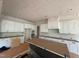 Unfinished kitchen featuring white cabinets and a black center island at 162 Gaines Trail, Pittsboro, NC 27312