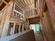 Unfinished living room showing framing, pink insulation, and exposed rafters at 162 Gaines Trail, Pittsboro, NC 27312
