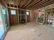 Unfinished living room with fireplace, exposed wooden beams, and staircase at 162 Gaines Trail, Pittsboro, NC 27312
