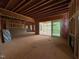 Unfinished living room featuring wood framing, a fireplace, and a sliding glass door to the outdoor patio at 162 Gaines Trail, Pittsboro, NC 27312