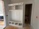 New mudroom featuring white cubbies, bench, and beadboard detailing near doorway at 162 Gaines Trail, Pittsboro, NC 27312
