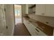 Walk-in pantry with white cabinets, quartz countertops, and ample storage space at 162 Gaines Trail, Pittsboro, NC 27312