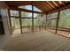 Large screened porch with exposed rafters overlooks a tranquil wooded backyard at 162 Gaines Trail, Pittsboro, NC 27312