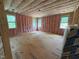 Unfinished room featuring pink insulation, wood framing, and multiple windows letting in natural light at 162 Gaines Trail, Pittsboro, NC 27312