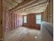 Unfinished room with pink insulation showing wood framing and a pair of windows at 162 Gaines Trail, Pittsboro, NC 27312