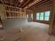 Unfinished room showing framing, pink insulation, and several windows at 162 Gaines Trail, Pittsboro, NC 27312