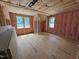 Unfinished room with pink insulation featuring wood framing and window at 162 Gaines Trail, Pittsboro, NC 27312