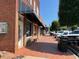 Brick buildings lining a pedestrian-friendly street in a charming town at 162 Gaines Trail, Pittsboro, NC 27312