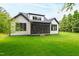 Expansive backyard showcases a well-maintained lawn and a stylish home with a screened-in porch at 5812 Shawood Dr, Raleigh, NC 27609