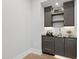 Stylish bar area features dark cabinets, marble countertop, and built-in shelving at 5812 Shawood Dr, Raleigh, NC 27609
