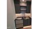 Stylish bar area with dark cabinets, granite countertop, and wine refrigerator at 5812 Shawood Dr, Raleigh, NC 27609