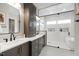 Spa-like bathroom with a double vanity, modern fixtures, and a separate glass-enclosed shower and soaking tub at 5812 Shawood Dr, Raleigh, NC 27609