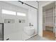 Modern bathroom featuring a glass-enclosed shower, freestanding tub, and a convenient walk-in closet at 5812 Shawood Dr, Raleigh, NC 27609