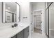 Bright bathroom with double vanity, black hardware, and access to a shower and closet at 5812 Shawood Dr, Raleigh, NC 27609