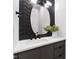 Chic powder room with a unique mirror, modern lighting, and a stylish vanity at 5812 Shawood Dr, Raleigh, NC 27609