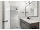 Modern bathroom featuring a gray vanity with white countertop and black fixtures, and a view into the bedroom at 5812 Shawood Dr, Raleigh, NC 27609