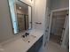 Modern bathroom featuring a quartz countertop, black fixtures, and a large, framed mirror at 5812 Shawood Dr, Raleigh, NC 27609
