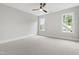 Spacious bedroom with plush carpet and natural light from two windows at 5812 Shawood Dr, Raleigh, NC 27609