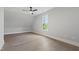 Bright bedroom with vaulted ceiling, hardwood floors, ceiling fan, and large window at 5812 Shawood Dr, Raleigh, NC 27609