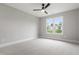 Bedroom with carpet, neutral walls, ceiling fan, and large window at 5812 Shawood Dr, Raleigh, NC 27609