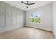 Bright bedroom with wood floors, ceiling fan, and geometric accent wall at 5812 Shawood Dr, Raleigh, NC 27609