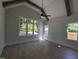 Bright bedroom with vaulted ceilings, hardwood floors, and large windows overlooking greenery at 5812 Shawood Dr, Raleigh, NC 27609