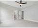 Neutral bedroom featuring fan and doorway to en suite bathroom and closet at 5812 Shawood Dr, Raleigh, NC 27609