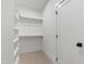 Spacious walk-in closet featuring custom shelving and ample storage space at 5812 Shawood Dr, Raleigh, NC 27609