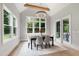 Bright dining room showcasing large windows overlooking the landscaped yard and a modern chandelier above the dining table at 5812 Shawood Dr, Raleigh, NC 27609