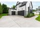Charming home exterior with a three-car garage, a long driveway, and professionally landscaped front yard at 5812 Shawood Dr, Raleigh, NC 27609