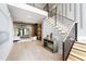 Open-concept foyer with wood floors leads to a modern living area and staircase at 5812 Shawood Dr, Raleigh, NC 27609